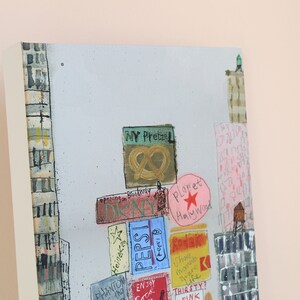 May include: A colorful abstract painting depicting a cityscape with various signs and advertisements. The signs include "Planet Hollywood", "Pepsi", "Dunkin", "NY Pretzel", and "Radar".