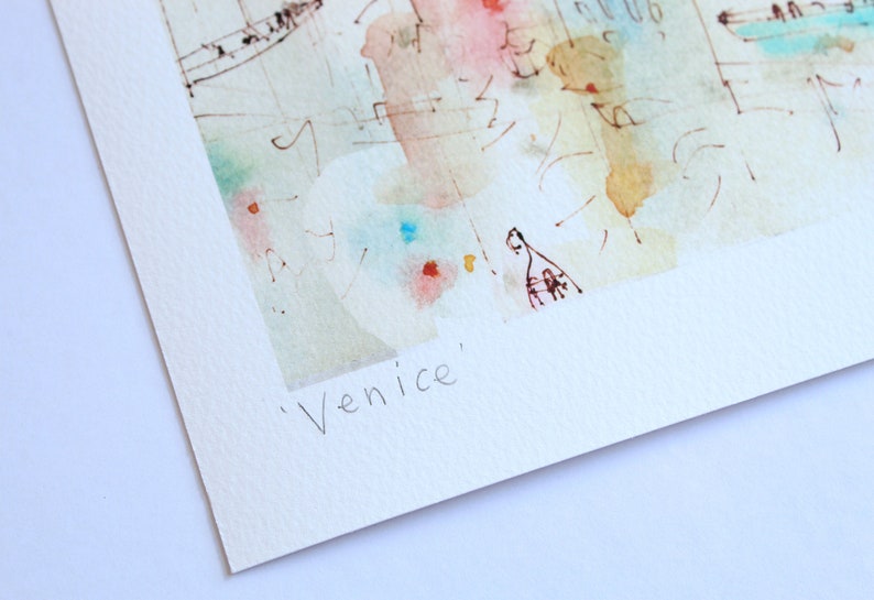 May include: A watercolour painting of Venice, Italy. The painting is in shades of blue, green, pink, and yellow. The text 'Venice' is written in black ink at the bottom of the painting.