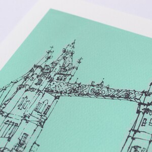 May include: A black and white line drawing of the Tower Bridge in London on a light green background.
