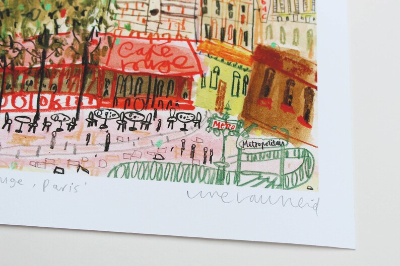 May include: A watercolor painting of a Parisian street scene with a cafe called "Cafe Rouge" and a Metro station. The painting is signed "une bauneid" in the bottom right corner.