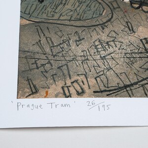 May include: A black and white print of a cityscape with the text 'Prague Tram' and '26/195' in the bottom right corner.