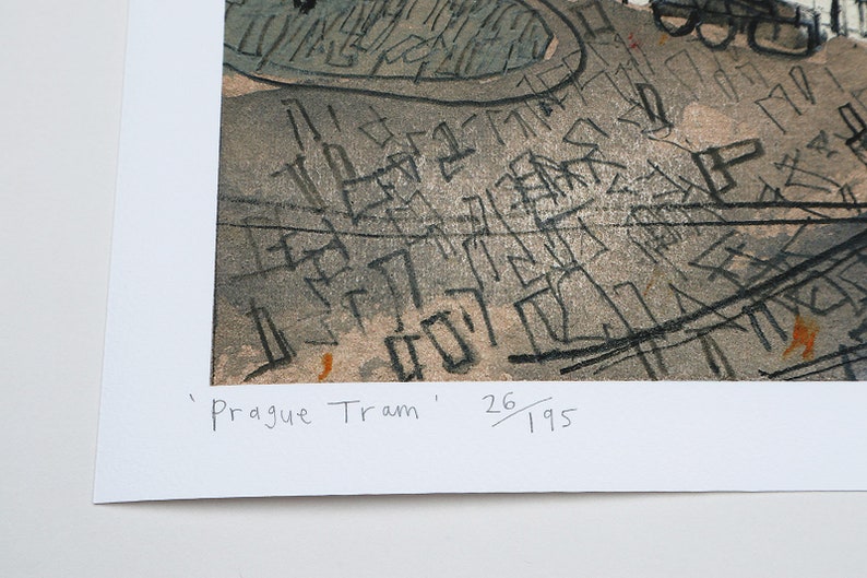May include: A black and white print of a cityscape with the text 'Prague Tram' and '26/195' in the bottom right corner.