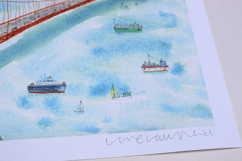 May include: A watercolor print featuring a red suspension bridge in the upper left corner and various boats, including a blue Horizon Lines cargo ship, a green vessel, and several smaller sailboats, floating on a light blue water surface.