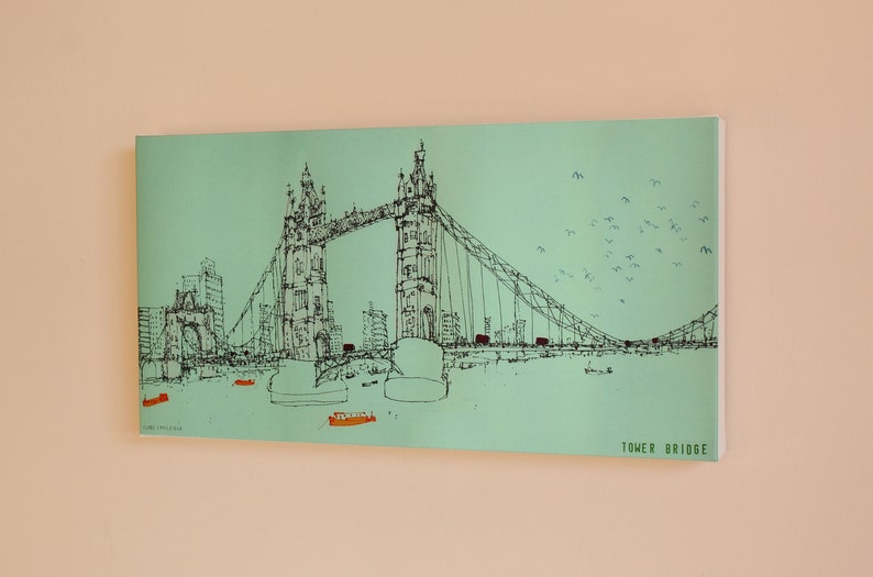 May include: A black and white line drawing of the Tower Bridge in London, England. The bridge is depicted against a light green background with a flock of birds flying overhead. The text "TOWER BRIDGE" is printed in black at the bottom right corner of the image.