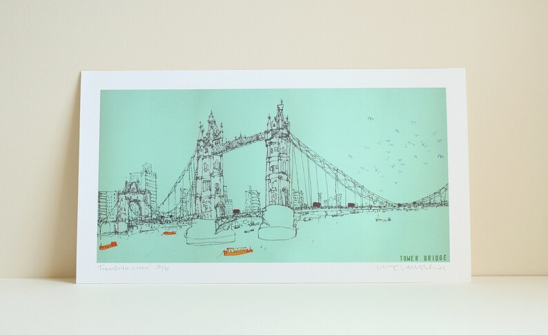 May include: A black and white line drawing of Tower Bridge in London, England. The bridge is depicted against a light blue background with a flock of birds flying overhead. The text "Tower Bridge" is written in the bottom right corner of the image.