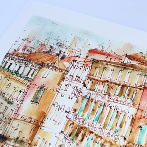 May include: Watercolour painting of a cityscape with buildings in shades of brown, red, and blue. The buildings have many windows and balconies. The painting has a light, airy feel.