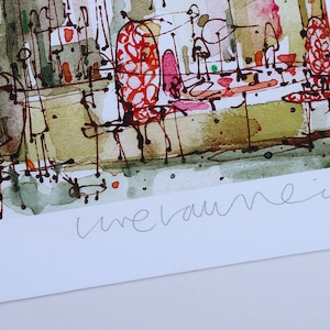 May include: A watercolor painting of a cafe scene with red and pink chairs, tables, and people. The painting is signed "unevaunie".