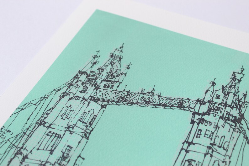 May include: A black and white line drawing of the Tower Bridge in London on a light green background.
