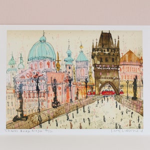 May include: A watercolor painting of Charles Bridge in Prague, Czech Republic. The painting features a view of the bridge with the iconic towers and the Vltava River in the background. The painting is done in a loose, expressive style with a mix of colors, including pink, blue, green, and brown.