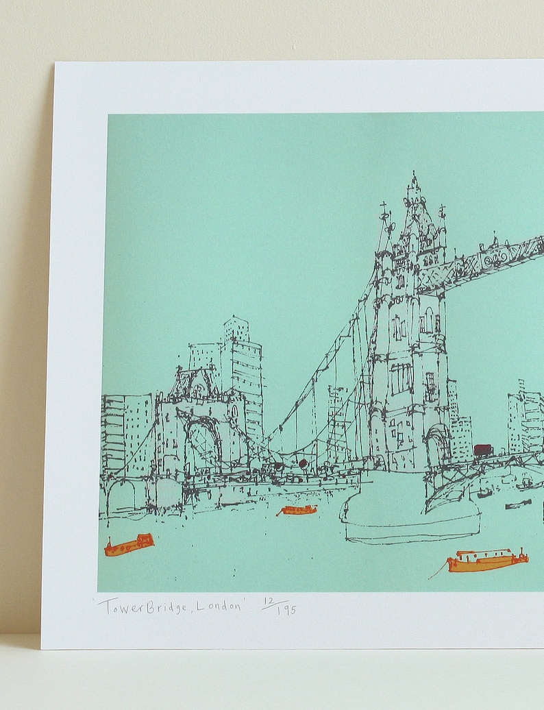 May include: A black and white line drawing of Tower Bridge in London, England. The bridge is drawn in a minimalist style with a turquoise background. The text "Tower Bridge, London" and "12/195" is written in the bottom right corner of the image.