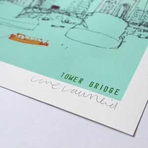 May include: A green and white print of the Tower Bridge in London, signed "live laumiel" in green ink.