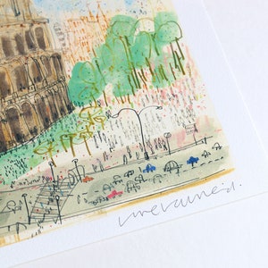 May include: Watercolor painting of a cityscape featuring a large, detailed building with arches, possibly a historical landmark. The artwork includes green trees, a street with cars, and pedestrian figures. The artist's signature is visible.