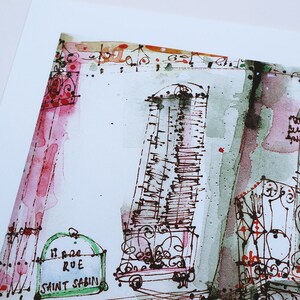 May include: A watercolor painting of a street scene in Paris, France. The painting features a building with a green door and a sign that reads "11 Rue Saint Sabin". The building is painted in shades of green, brown, and pink.
