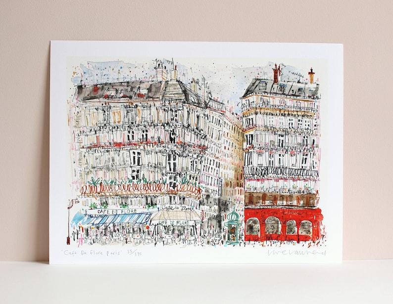 May include: A watercolor illustration of a Parisian street scene featuring the Cafe de Flore. The cafe is depicted with a blue awning and a sign that reads "Cafe de Flore". The illustration is in a sketchy style with a lot of detail.
