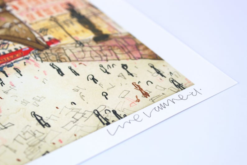 May include: A close-up of a signed art print with a whimsical illustration of a city scene. The signature reads "Lune Vermeil."