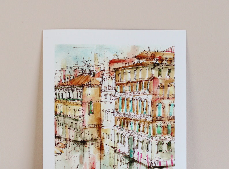 May include: Watercolour painting of a canal in Venice, Italy. The painting features several buildings with colourful facades and windows. The canal is reflected in the water, and there are boats in the distance.