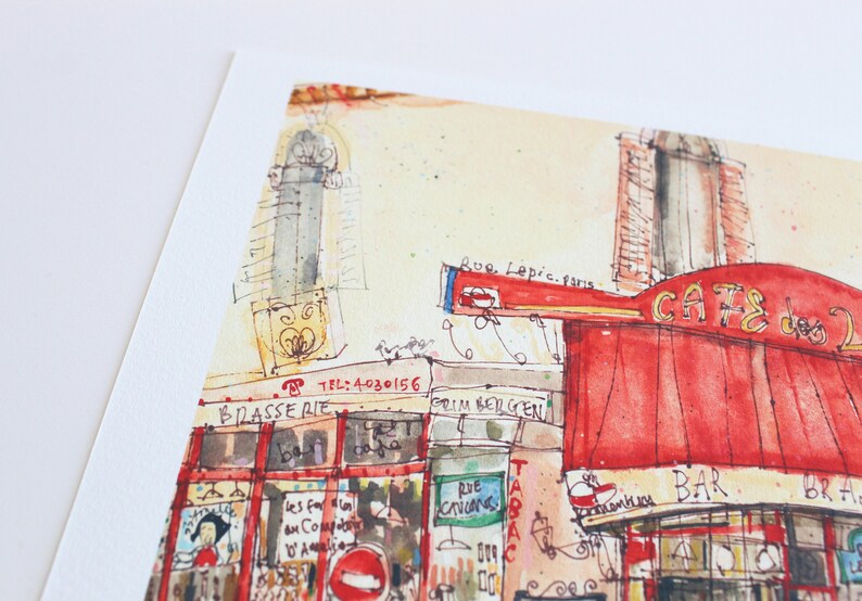 May include: Watercolor painting of a Parisian cafe with a red awning and the words "CAFE des 2 Moulins". The artwork includes the text "BRASSERIE", "TABAC", and "Rue Lepic, paris". The style is loose and impressionistic, with visible brushstrokes.