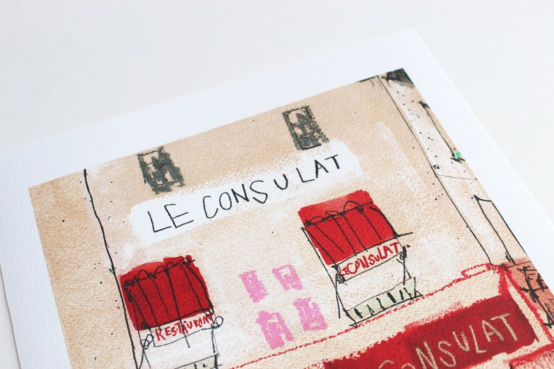 May include: A hand-drawn illustration of a building with the text "LE CONSULAT" above a red window with the text "RESTAURANT" below it. There is a pink window with the text "LE CONSULAT" below it. The building is drawn in a cartoon style with a textured background.