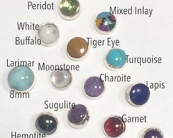 May include: Assortment of 14 gemstone cabochons, most are 6mm in diameter, except the turquoise cabochon which is 8mm. Stones include peridot, white buffalo, citrine, mixed inlay, tiger eye, larimar, moonstone, charoite, turquoise, lapis, sugilite, hemotoite, gaspeite, garnet, and amethyst.