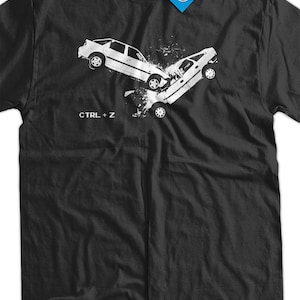May include: Black t-shirt with a white graphic of two cars crashing. The text "CTRL + Z" is printed below the graphic.
