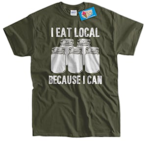 May include: A green t-shirt with the text "I eat local because I can" in white. The text is surrounded by five white jars.