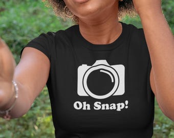 May include: A black t-shirt with a white camera graphic and the text "Oh Snap!" printed on the front.