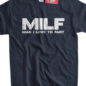May include: A navy blue t-shirt with white text that reads "MILF MAN I LOVE TO FART".