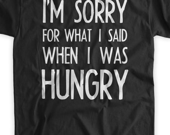 May include: Black t-shirt with white text that reads "I'm sorry for what I said when I was hungry".