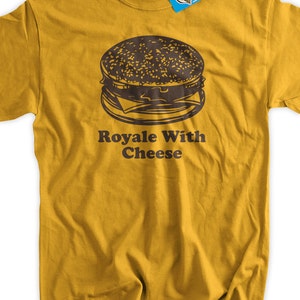 May include: A mustard yellow t-shirt with a black and white illustration of a burger and the text "Royale With Cheese".
