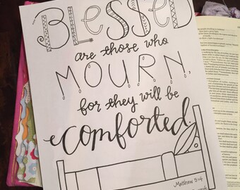 May include: Black and white printable art print with the text "Blessed are those who mourn, for they will be comforted."  The text is in a decorative font and includes a small bed illustration. The text "Matthew 5:4" and a website address are also included.