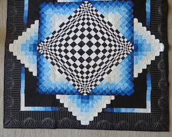 Op art wall quilt in black and white with blue accents