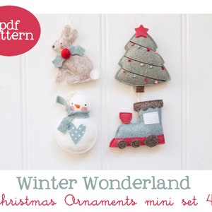 May include: A set of four felt Christmas decorations, featuring a bunny, a Christmas tree, a snowman, and a train. The decorations are all in a winter wonderland theme and are ideal for adding a touch of whimsy to your festive decor.