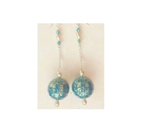 May include: A pair of long, silver dangle earrings with blue and gold glass beads. The beads are round and have a textured surface.