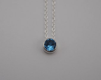 Birthstone Necklace: Round Blue Zircon, Bezel, Silver, Cable Chain