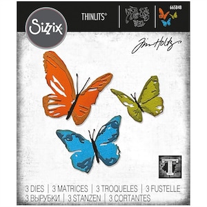 May include: A package of three die-cut butterfly shapes for crafting. The butterflies are orange, green, and blue. The package is labeled "Sizzix Thinlits" and "Jim Holtz".