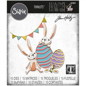 May include: A set of 15 die-cut metal shapes for crafting. The design features two bunnies holding Easter eggs with a banner of flags above them. The die cuts are designed by Jim Holtz for Sizzix.