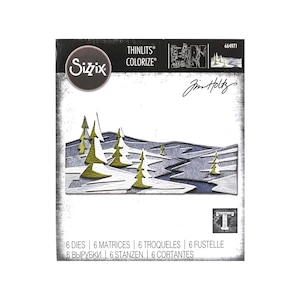 May include: A package of Sizzix Thinlits Colorize dies featuring a winter landscape design. The die-cut design includes stylized trees in green and gold, set against a gray and white background. The package includes the text "6 DIES | 6 MATRICES | 6 TROQUELES | 6 FUSTELLE".
