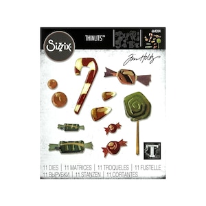May include: Sizzix Thinlits die set featuring candy-themed designs. Includes a candy cane, lollipops, wrapped candies, and other sweet treats. The set includes 11 dies. The Jim Holtz signature is visible.