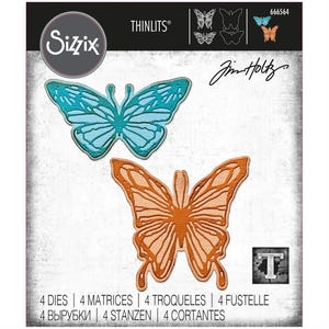 May include: Sizzix Thinlits die set featuring butterfly designs. The package includes two butterfly die cuts in blue and orange, with the text "Sizzix" and "Jim Holtz". The package also includes the text "4 DIES | 4 MATRICES | 4 TROQUELES | 4 FUSTELLE | 4 ВЫРУБКИ | 4 STANZEN | 4 CORTANTES".