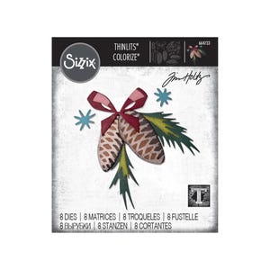 May include: Sizzix Thinlits Colorize die set featuring a festive design with two pinecones, a red bow, green pine needles, and blue snowflakes. The set includes 8 dies for crafting and paper projects.