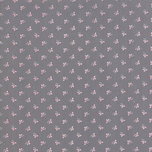 May include: A gray fabric with a repeating pattern of small white and pink flowers.
