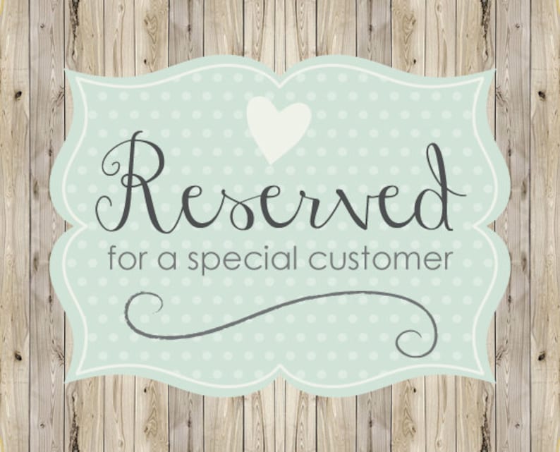 May include: A light blue, scalloped-edge sign with the words "Reserved for a special customer" in dark gray script. A white heart is at the top, and the background is a light blue with white polka dots. The background is a wooden plank design.