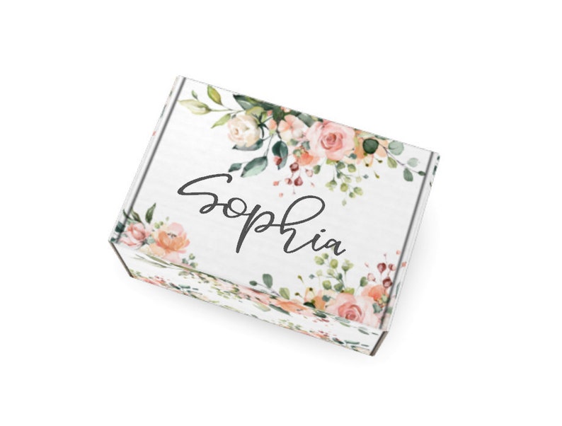 May include: A white gift box with a floral design featuring pink and peach roses, green leaves, and the name "Sophia" in black script. The box is decorated with watercolour-style flowers.