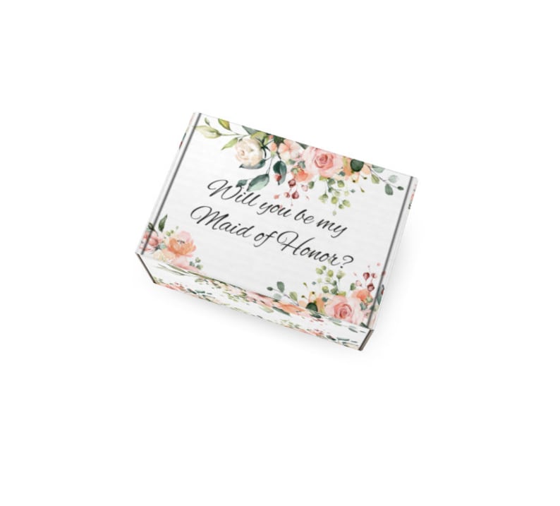 May include: A white gift box featuring the text "Will you be my Maid of Honor?" surrounded by floral illustrations. The box is adorned with watercolour roses and foliage, ideal for a wedding proposal or bridesmaid gift.