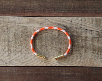Dreamsicle Camo Bullet Casing Bracelet recycled .22lr casings orange white paracord wire BRZN