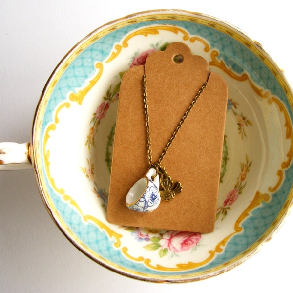 Tiny blue and white china teacup necklace with little bronze bird