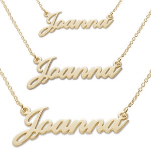 May include: Three gold-coloured Joanna name necklaces with delicate chain links. The cursive name pendants are displayed at different angles, showcasing the jewellery's design and craftsmanship. The necklaces are presented against a white background.