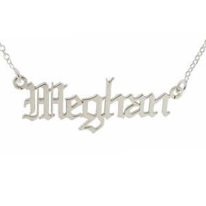 May include: Silver necklace with the name "Meghan" spelled out in a gothic font.