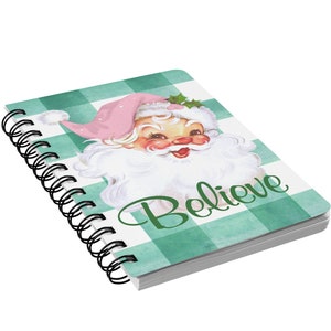 May include: A green and white checkered spiral notebook with a vintage illustration of Santa Claus on the front. The notebook says "Believe" in green letters.