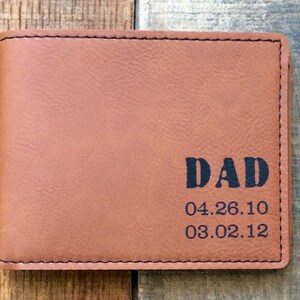 May include: Brown leather wallet with the word "DAD" and the dates "04.26.10" and "03.02.12" embossed on the front.